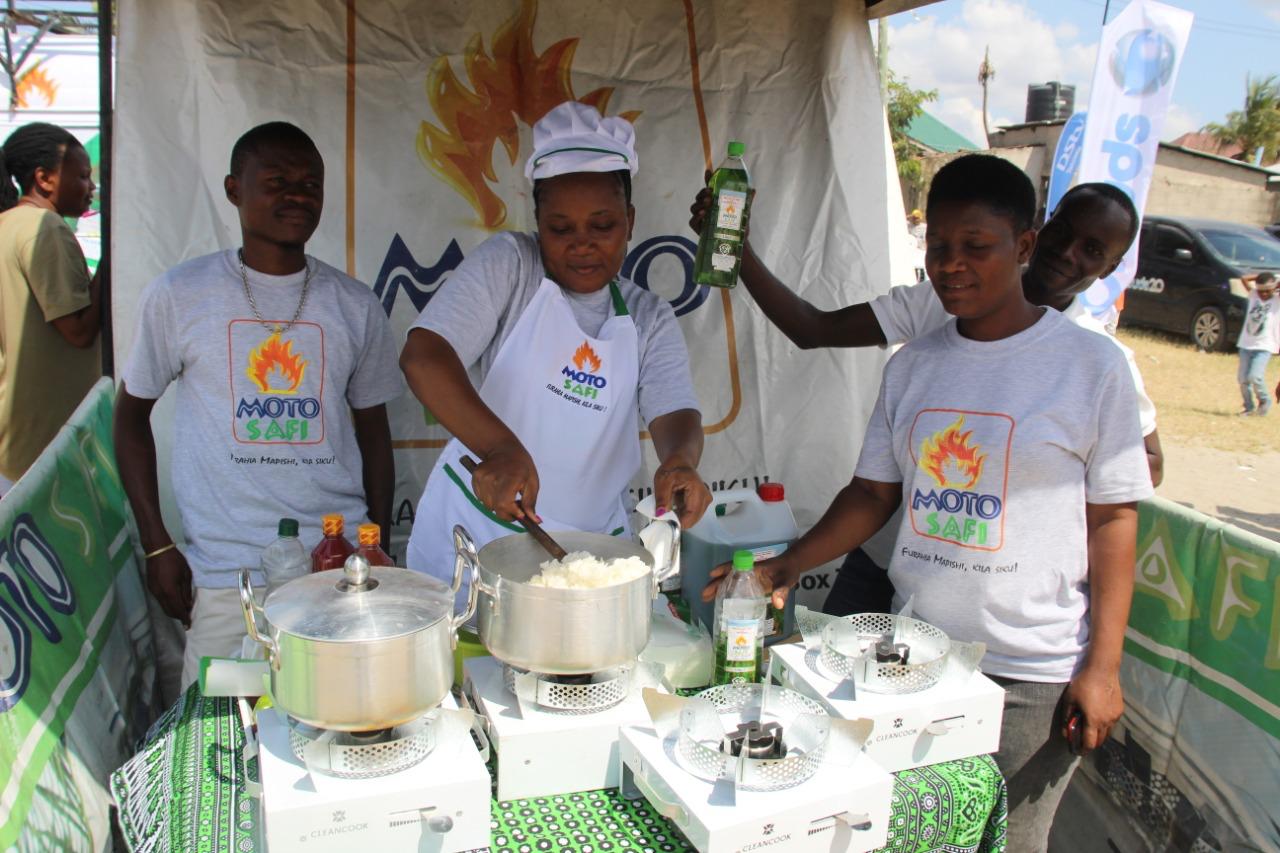 Moto Safi team demonstrating ethanol cook stoves at a community event